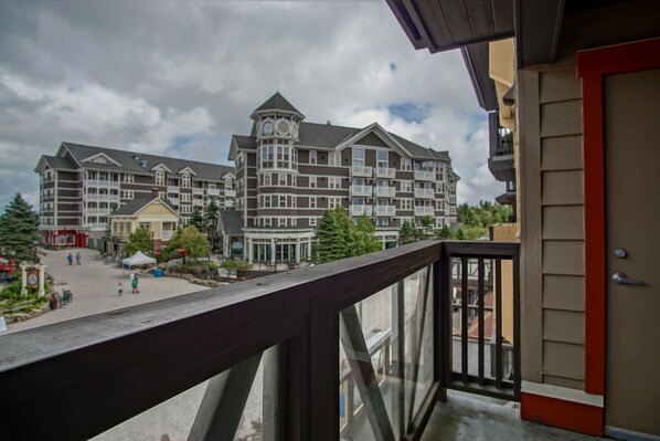 A multi-story hotel with a central courtyard, balconies, and a clock tower. - Rimfire 322-323: Combined 2 one Bedroom Units, Slopeside (Snowshoe)
