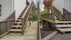 A wooden staircase with a handrail leading to a wooden deck. - Whistlepunk #24: 4 Bedroom, 3 Bath: Slope Side, Wood Fireplace (Snowshoe)