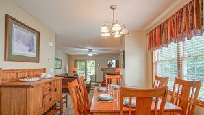A dining area with a wooden table set for four, a wooden bench, and a fireplace. - Creekside E17, Frisco Kid Retreat Jacuzzi Sleeps 11 (Snowshoe)