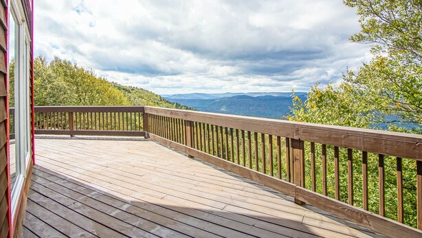 A wooden deck with a railing overlooking a mountainous landscape. - South West Ridge 72-153 5 Br: Large Western Views. Private hot Tub. Wood Fireplace (Snowshoe)