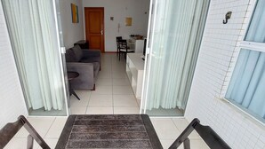 A staircase leading to a living area with a sofa and a dining table. - COOND0102 - Ondina Residence (Salvador)