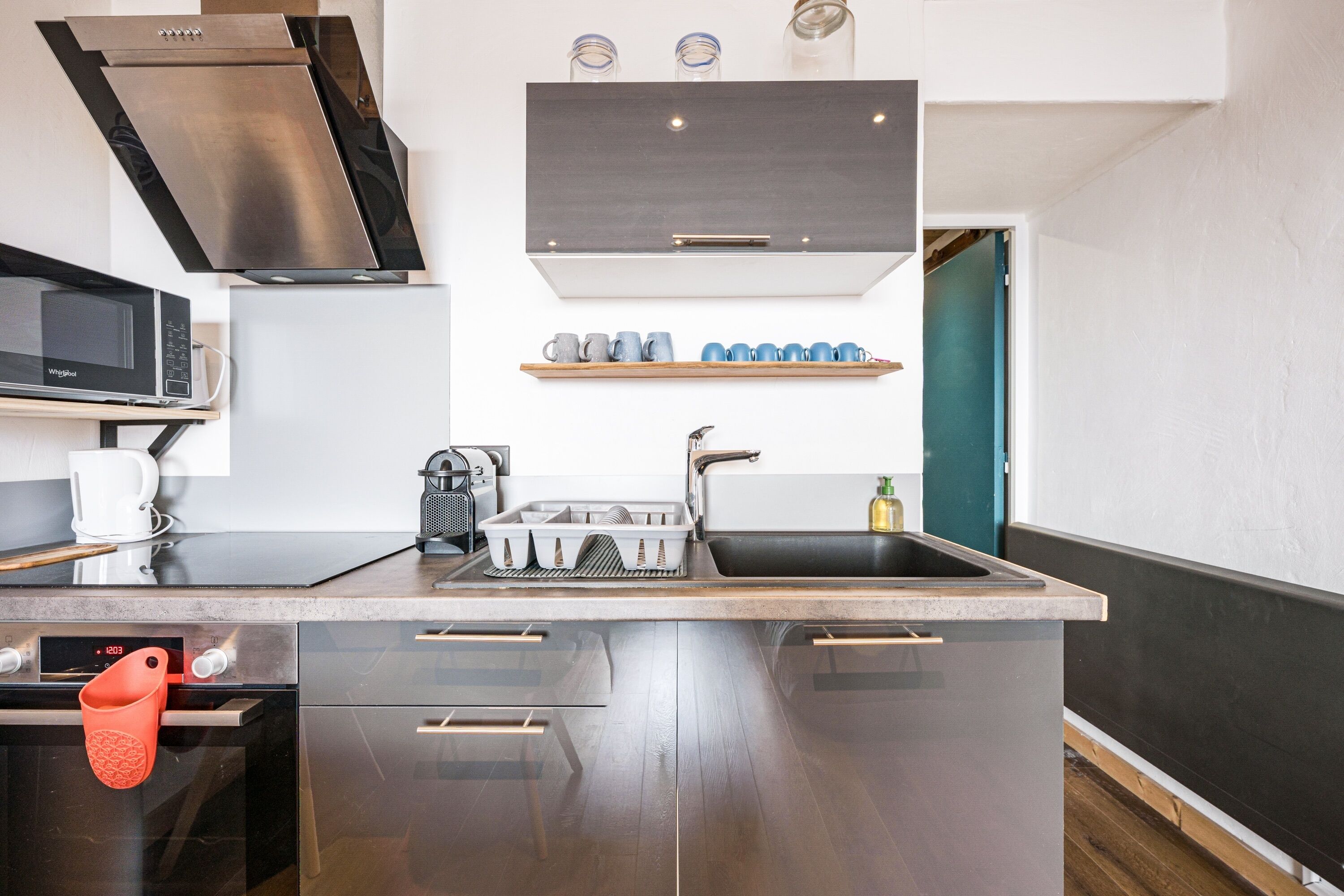 A modern kitchen with stainless steel appliances, a built-in oven, and a microwave.