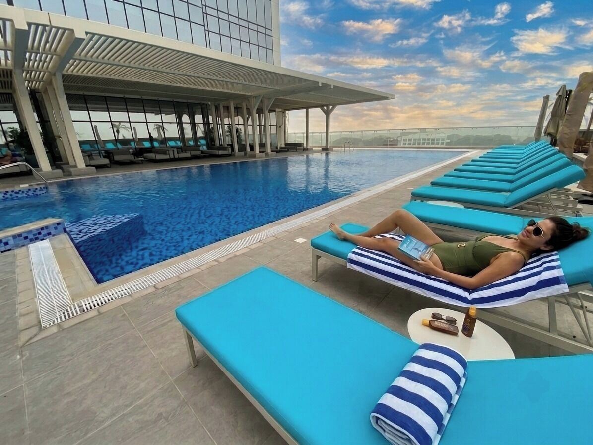 A poolside area with lounge chairs and a pool.