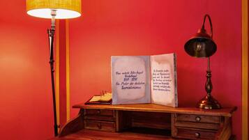 A desk with a lamp, a book, and a lamp on the right side.