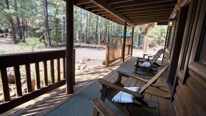 A covered outdoor area with wooden benches and a picnic table, surrounded by trees. - Christmas Tree Retreat – Cozy Forest Getaway in Pinetop - Sleeps 8 (Pinetop Country Club)