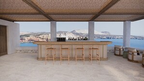 A bar area with a view of a mountainous landscape. - Erema, a Member of Design Hotels (Milos)