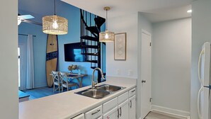 A modern kitchen with white cabinets, a double sink, and pendant lighting. - Treasure Cove #d308 - Paradise City (Panama City Beach)