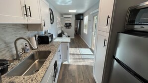 A modern kitchen with granite countertops, stainless steel appliances, and a walk-in pantry. - Unique 1-bdrm poolhouse with 24hr access to Pool & Jacuzzi (Phoenix)