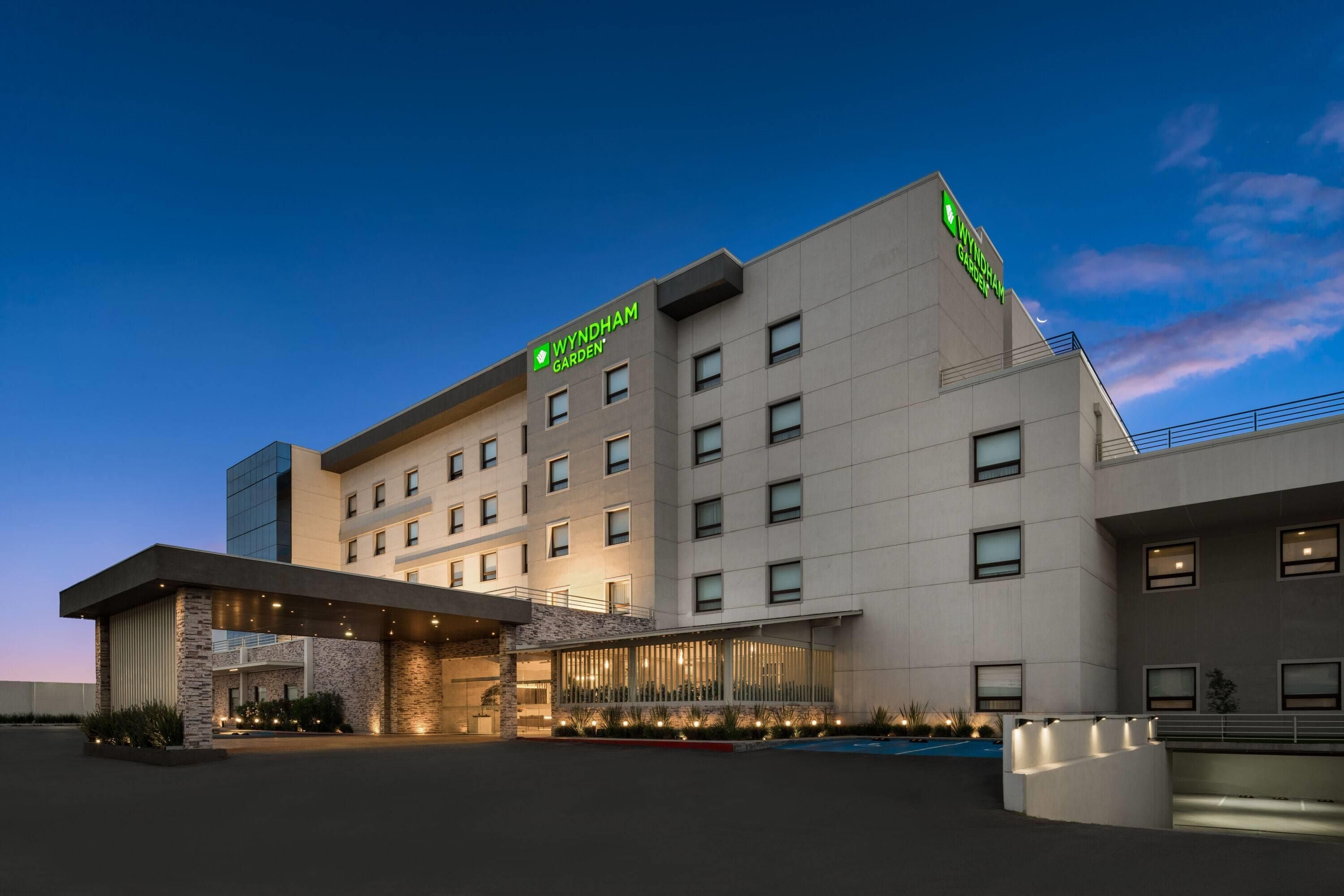 A Wyndham Garden hotel with a modern design, featuring a prominent entrance and multiple floors.