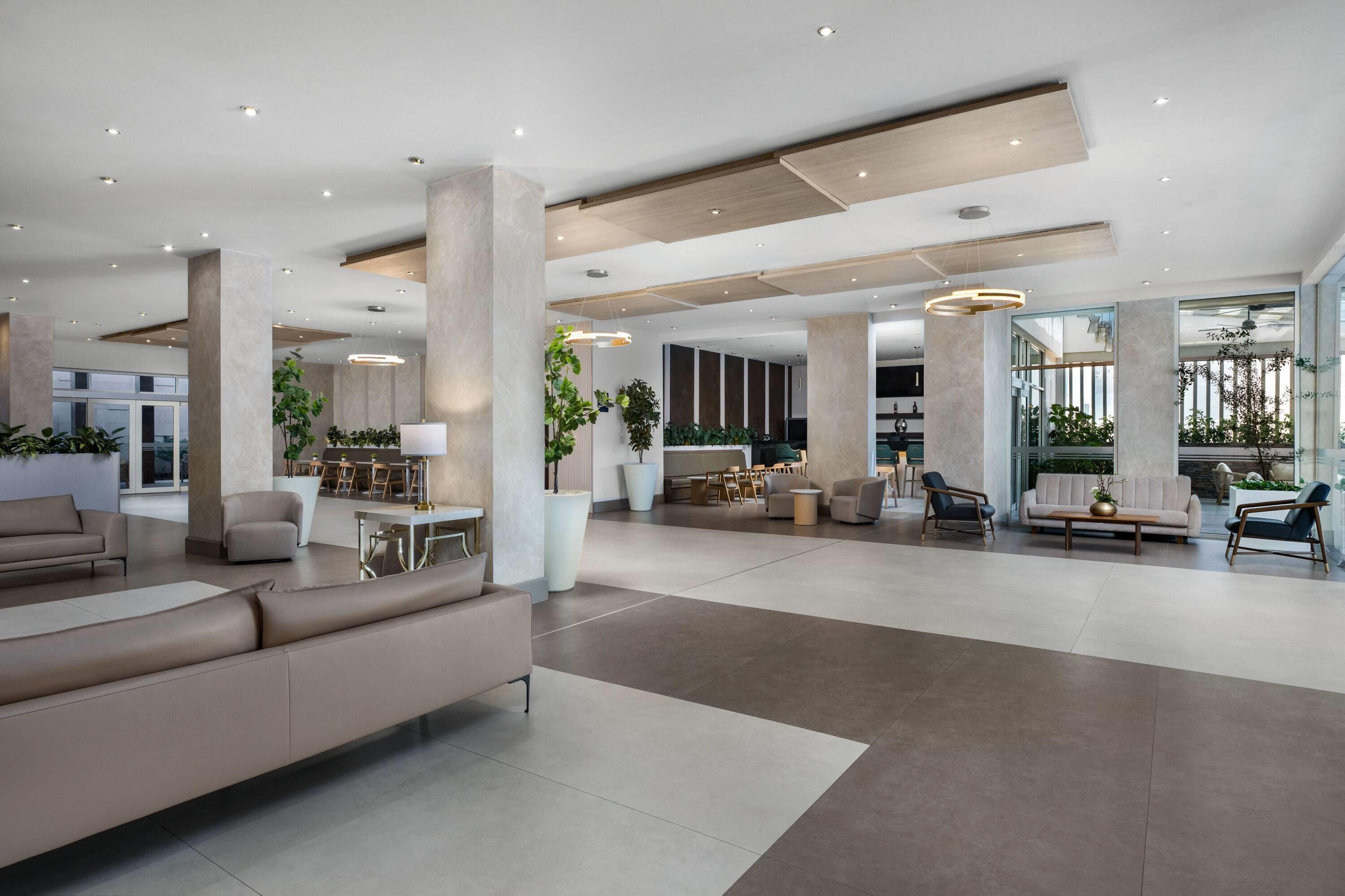 A spacious, modern living area with a large sofa, multiple seating options, and a dining area.