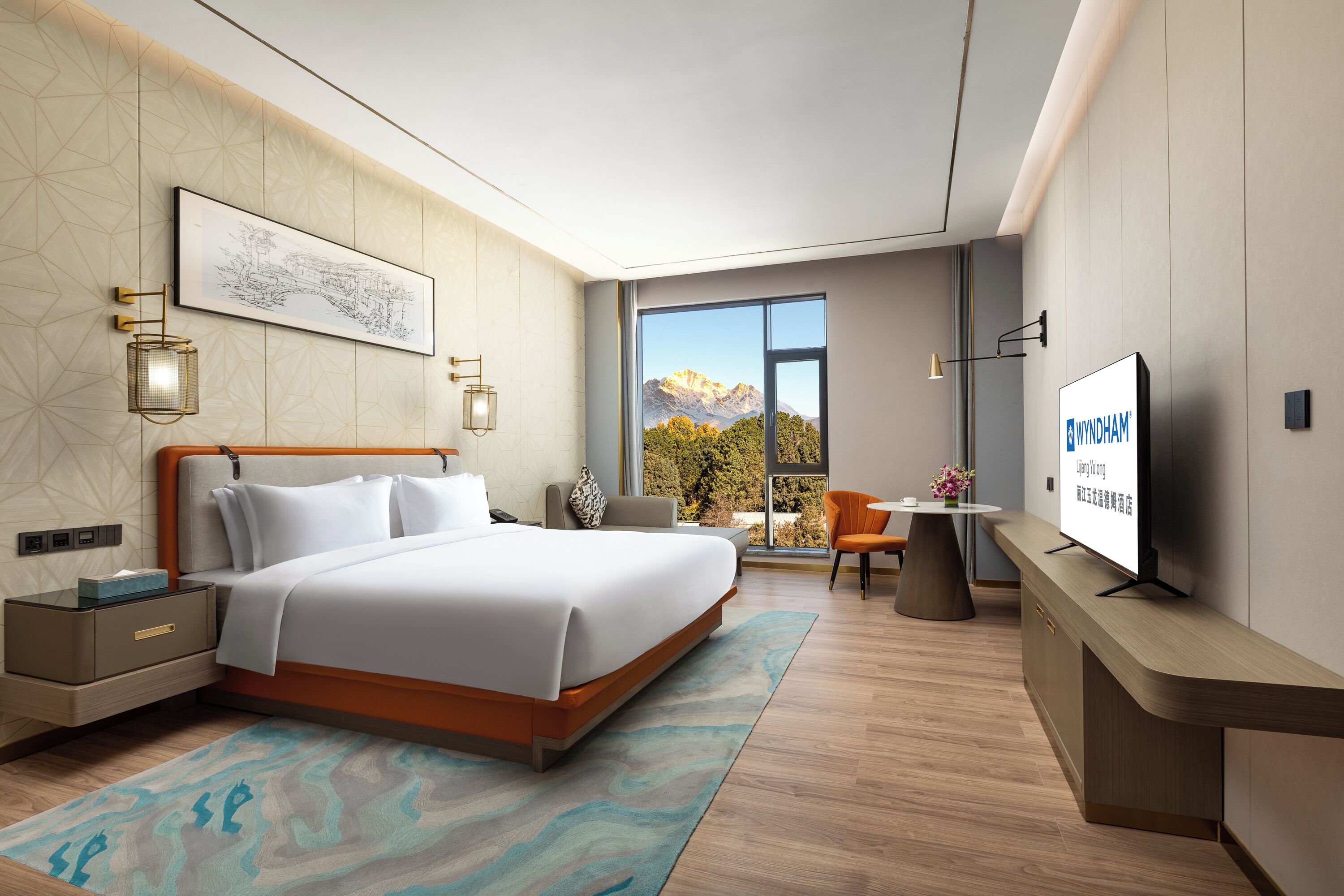 A modern hotel room with a bed, bedside tables, a desk, a television, and a large window offering a mountain view.
