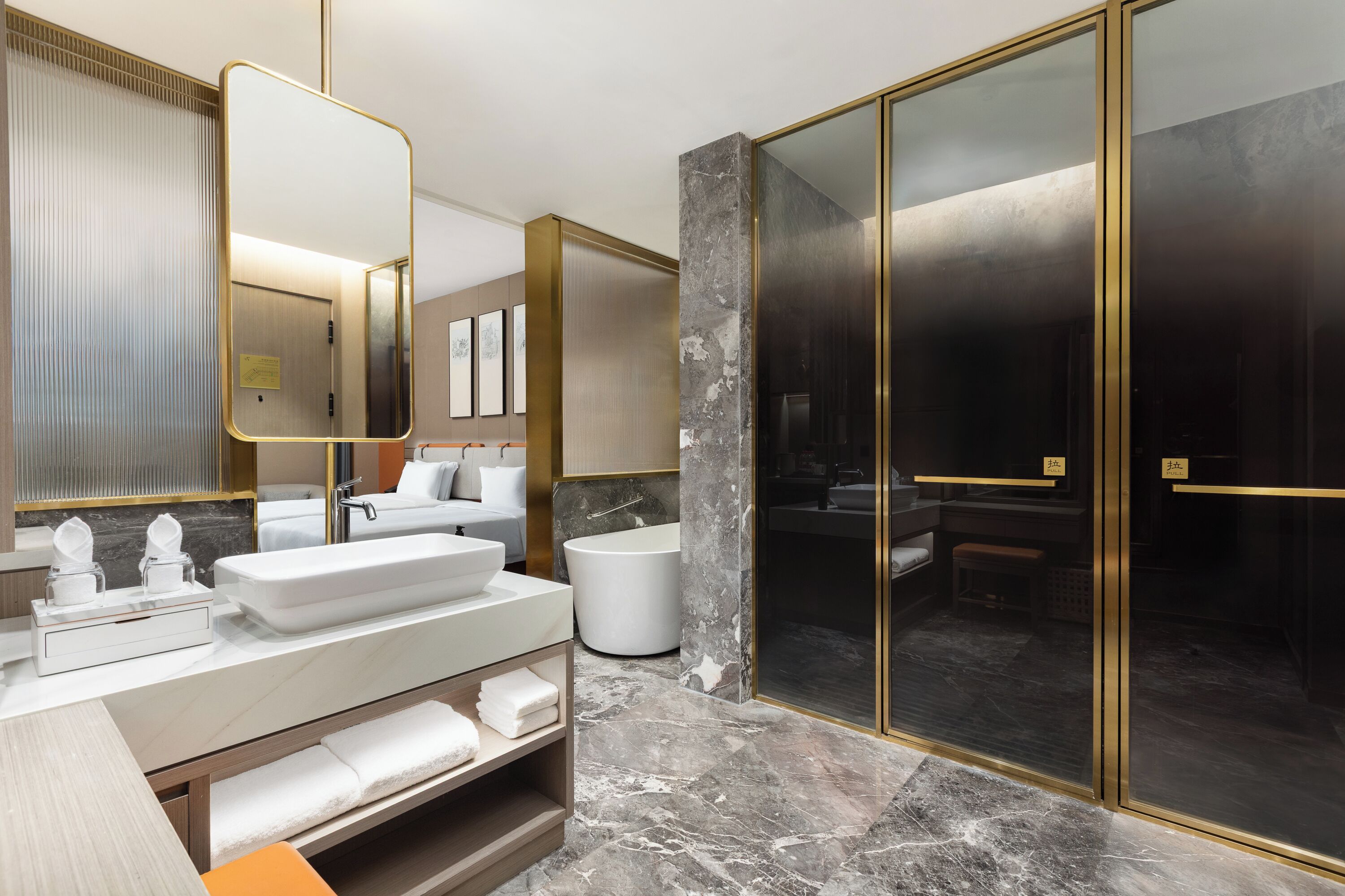 A modern bathroom with a large mirror, a white sink, a bathtub, and a glass-enclosed shower area.