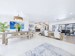 A spacious, modern interior with a dining area, kitchen, and seating space. - 3 Bedroom Waterfront Pool Villa with Gulf Access (Cape Coral)