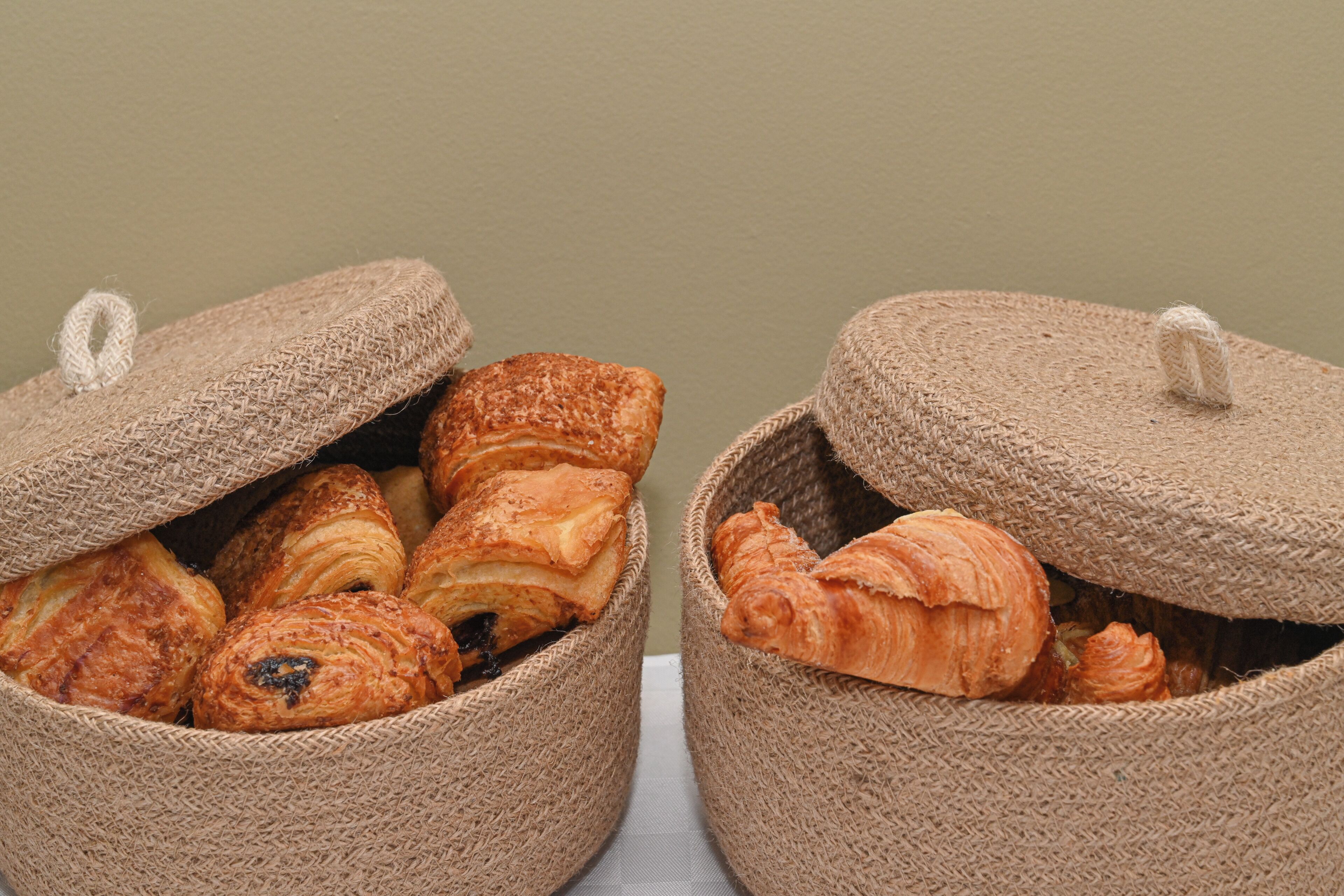 Two burlap bags filled with pastries.