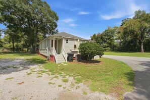 A single-story house with a front porch, a small front yard, and a driveway.