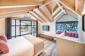 A modern bedroom with a large bed, a TV, and a view of the outside. - Villa Fire by Villa Plus (Kariotes)
