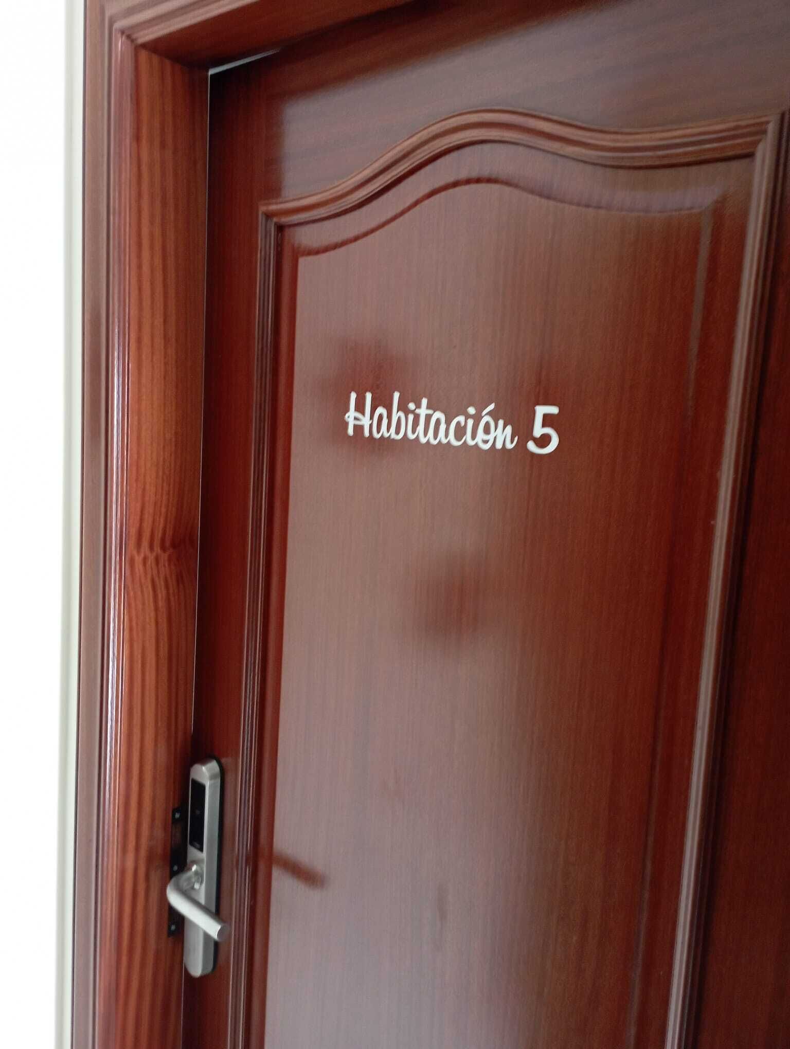 A wooden door with the text "Habitación 5" indicating room number 5.