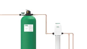 A green fire suppression system with a white control unit connected by copper pipes.