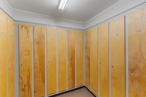 A row of wooden lockers with numbers on them.