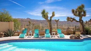 A pool with lounge chairs, desert vegetation, and a mountainous backdrop. - Desert Shadows by Avantstay Breathtaking Views & Pool (Joshua Tree)