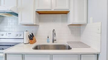 Fridge, coffee/tea maker, cookware/dishes/utensils, dining tables