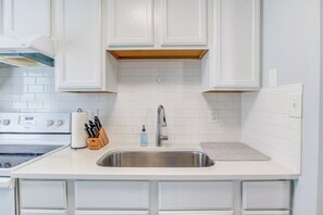 Frigorífico, cafetera o tetera, utensilios de cocina y mesa de comedor