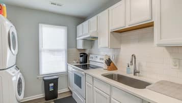 Fridge, coffee/tea maker, cookware/dishes/utensils, dining tables