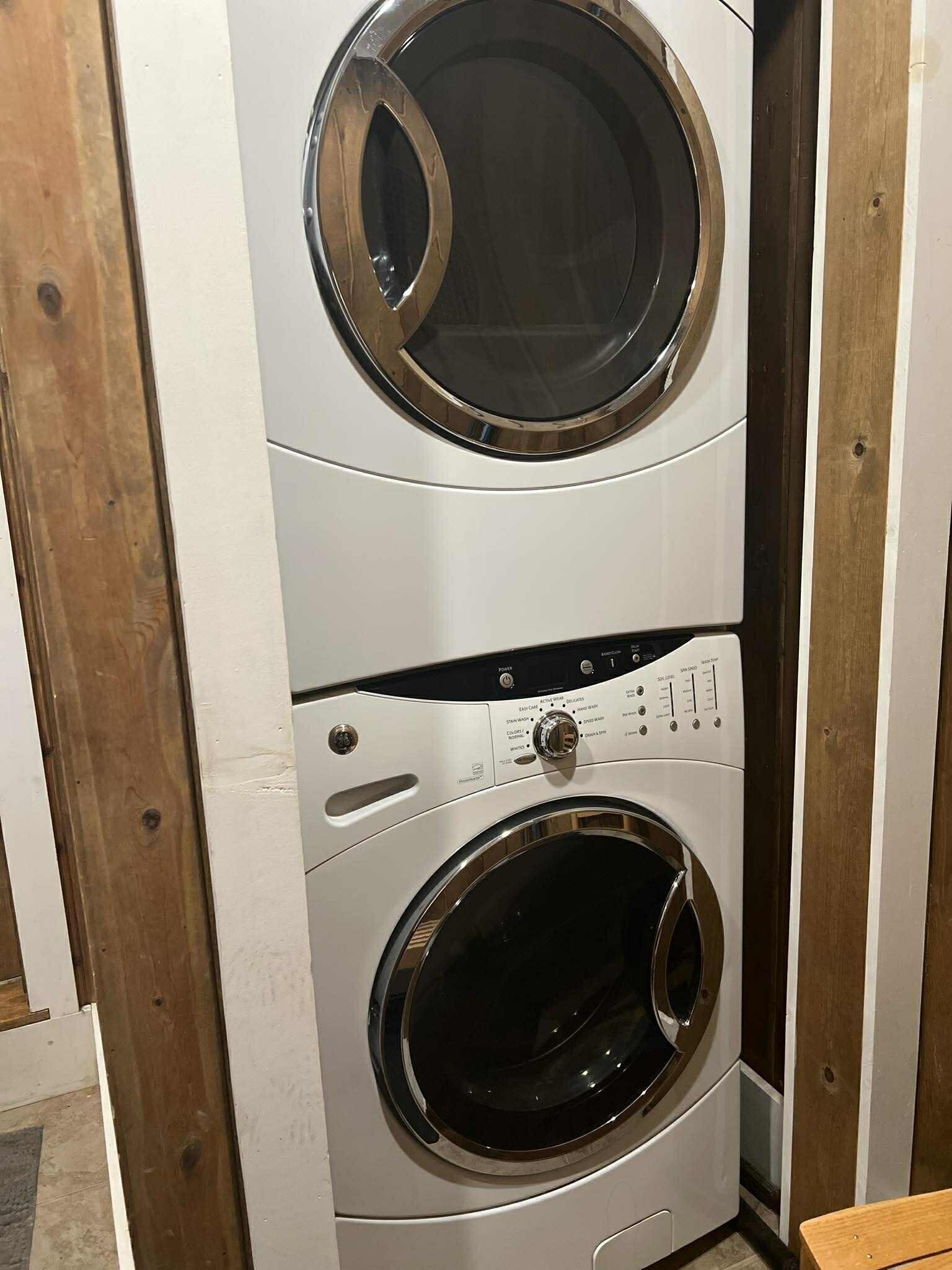 A stacked washer and dryer unit with control panels and a front door.
