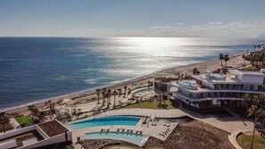 A resort with a pool, beach, and ocean view. - TE- Luxury Resort, Front Line Beach, Families Only (Estepona)