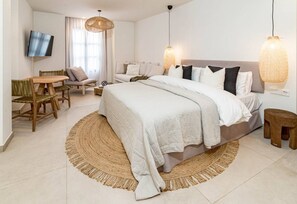 A modern bedroom with a large bed, a desk, and two chairs. - A1- Seaclub Suites by Roomservices (Estepona)