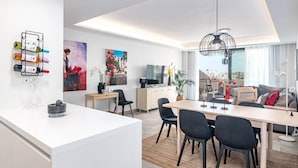 A modern living room with a dining area, a TV, and a city view. - Inf46p - Spacious Holiday Home in Estepona (Estepona)