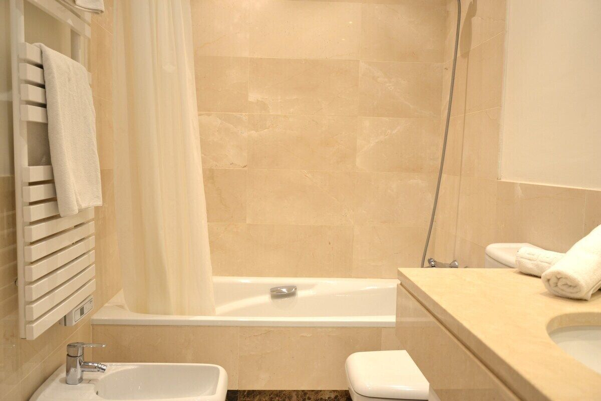 A bathroom with a bathtub, a sink, and a toilet.