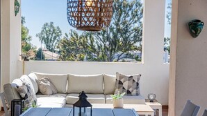 A sunlit patio with a sofa, table, and hanging lantern. - Lcr4 - Large 3-bedroom Apartment Near Beach (Marbella)