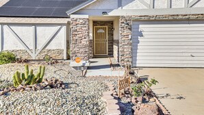 A house with a stone facade, a garage, and a cactus garden. - Private Pool & Fenced Yard: Sunny Glendale Getaway (Glendale)