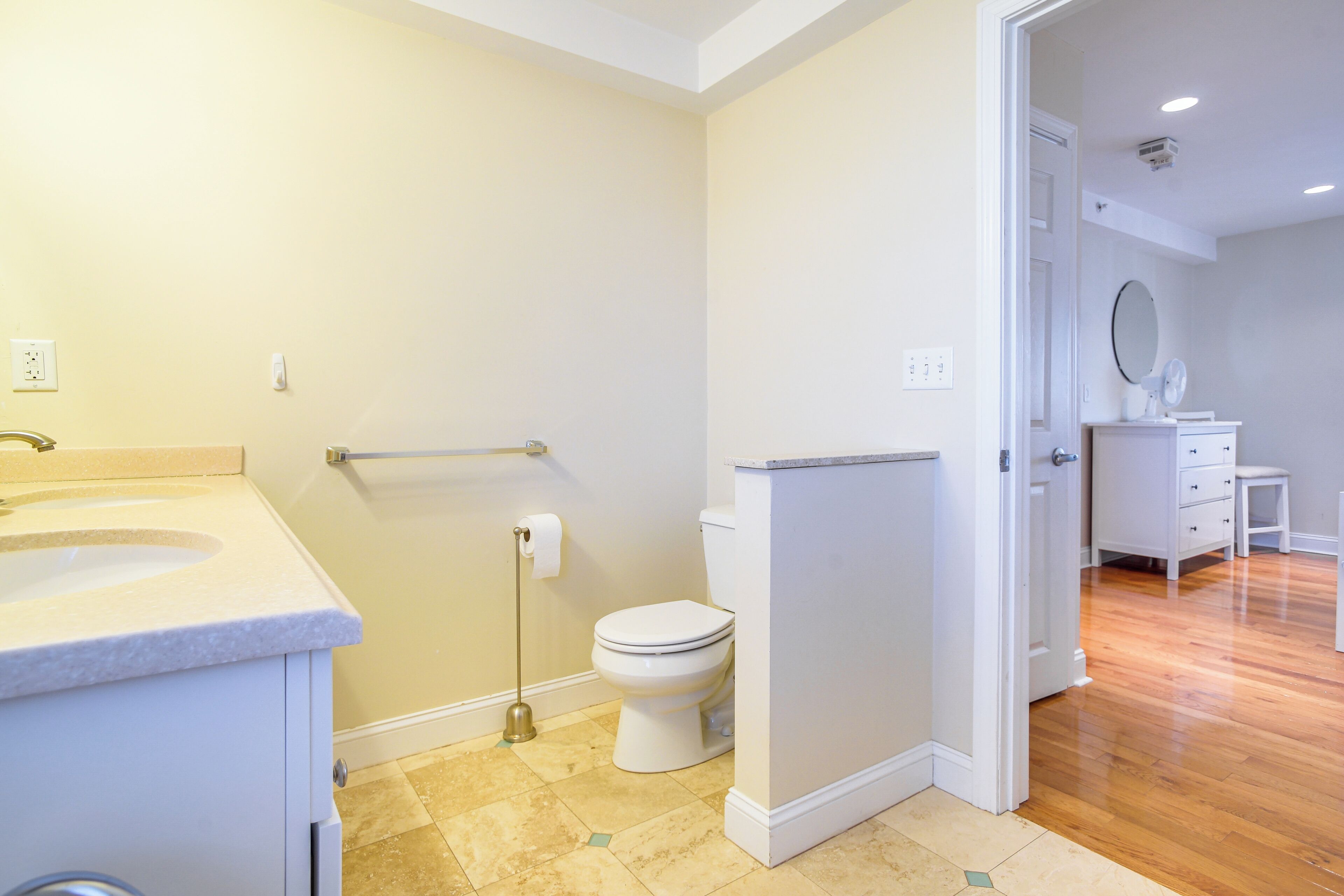 A bathroom with a toilet, sink, and shower area.