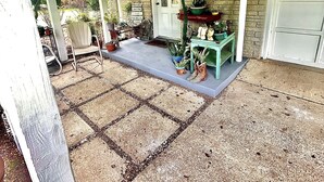 A covered porch with a brick wall, a door, and a small table with potted plants. - Dragonfly Cove + Hot Tub • Fire Pit • Lake Views • Sleeps 10 (Estill Springs)