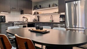 A modern kitchen with a central island, stainless steel appliances, and a contemporary design.