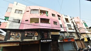 A multi-story building with various shops on the ground floor, including a Black Denim store. - Hotel Vishwas Lok (Ujjain)