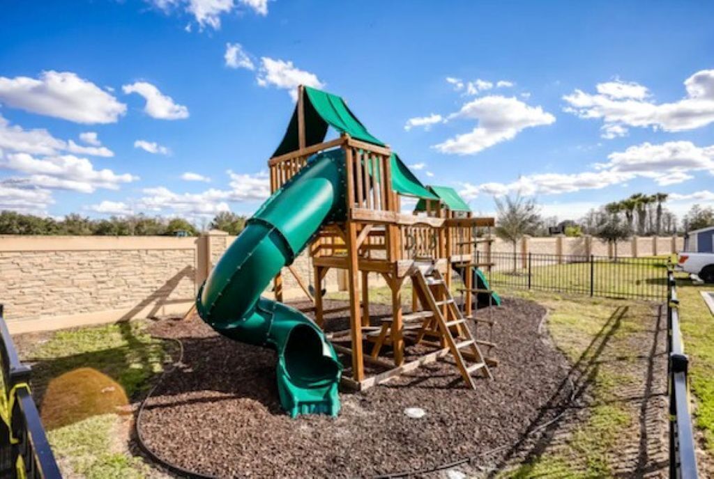 A playground with a slide and climbing structures.