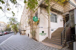 A building with a sign for 'Clover Boutique Hotel' and a staircase leading to an entrance. - Clover Hotel (Baku)