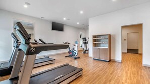 A modern gym with treadmills, an exercise bike, and a water station. - Ocean-View Studio at Flamingo Beach – Beachfront St. Maarten Escape (Philipsburg)
