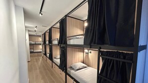 A corridor with bunk beds, wooden walls, and a tiled floor. - ALMA one (Alicante)