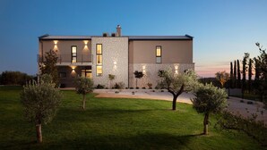 A modern two-story house with a stone facade, multiple windows, and a well-maintained lawn. - Cozy home in Bale with sauna (Bale)