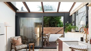 A modern kitchen with a sliding glass door leading to a patio area. - Traditional Cornish Cottage & Garden, Redruth (Redruth)