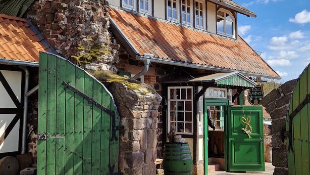 A traditional building with a steeply pitched roof, multiple windows, and a stone wall. - ☆High quality ☆Cozy ☆Rain shower ☆Terrace ☆Garden house ☆Parking space (Neustadt/Harz)