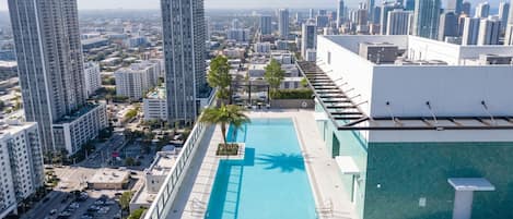 A rooftop pool with a cityscape view, surrounded by high-rise buildings.