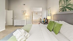 A hotel room with a large bed, a dresser, a mirror, and a painting on the wall. - Marbella Lane - 4BR SiliconValley Gem Pool House (San Jose)