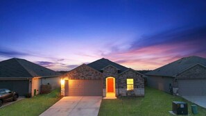 A residential neighborhood with houses featuring stone facades and pitched roofs. - Marbella Lane - Amazing 4BR Lakeview Home (Austin)