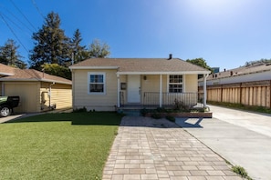 A single-story house with a front porch, a small front yard, and a driveway leading to the garage. - Marbella Lane - Convenient Home in Sunnyvale (Sunnyvale)