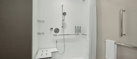 Ein modernes Badezimmer mit Dusche, Toilette und Handtuchhalter.